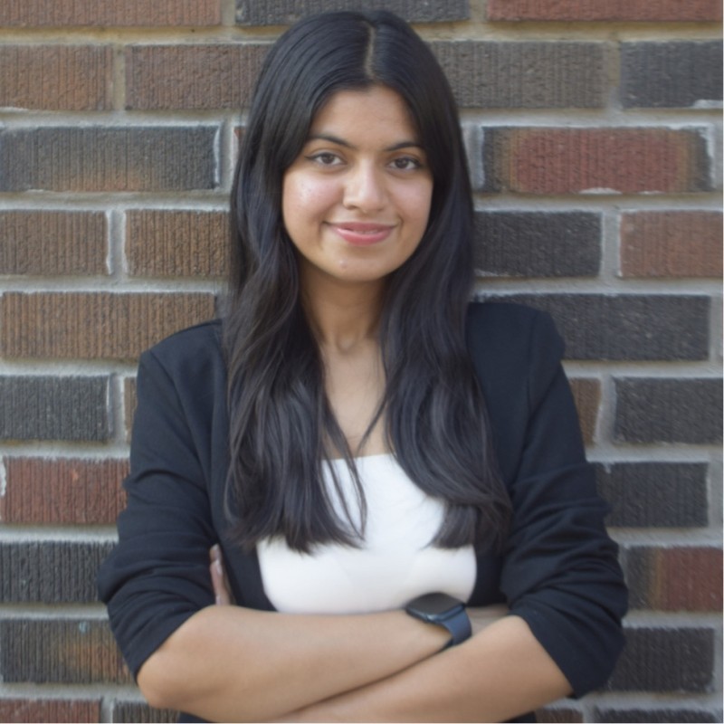 Parul with her arms crossed demonstrating quiet confidence